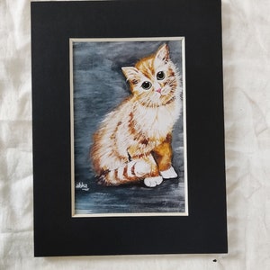 May include: A watercolor painting of a cute orange and white kitten with green eyes, sitting on a gray background. The kitten is looking directly at the viewer. The painting is signed "abhz" in the bottom left corner.