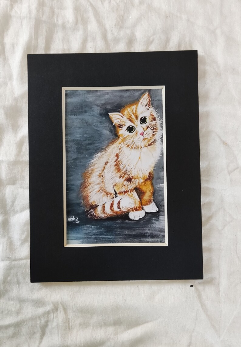 May include: A watercolor painting of a cute orange and white kitten with green eyes, sitting on a gray background. The kitten is looking directly at the viewer. The painting is signed "abhz" in the bottom left corner.
