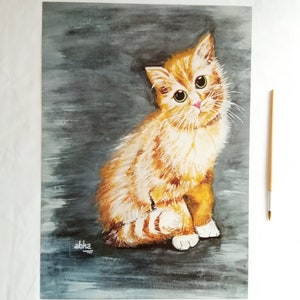 May include: A painting of a ginger kitten with white markings sitting on a gray background. The kitten has large green eyes and a pink nose. The painting is signed "abha" in the bottom left corner.
