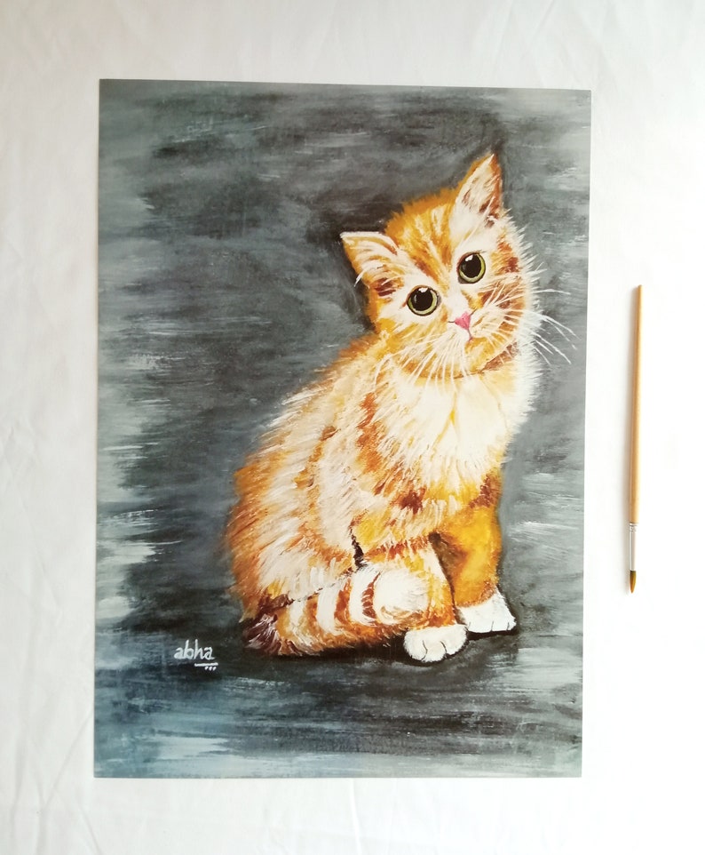 May include: A painting of a ginger kitten with white markings sitting on a gray background. The kitten has large green eyes and a pink nose. The painting is signed "abha" in the bottom left corner.