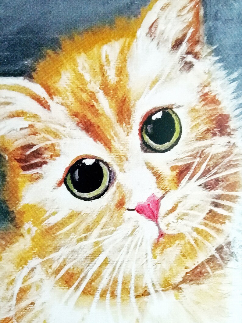 May include: A close-up of a white and orange cat with green eyes. The cat is looking directly at the viewer with a curious expression.
