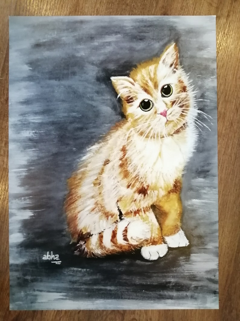 May include: A watercolor painting of a ginger kitten with green eyes, sitting on a gray background. The kitten is looking up and to the right, with its tail curled around its body. The painting is signed "abha" in the bottom left corner.