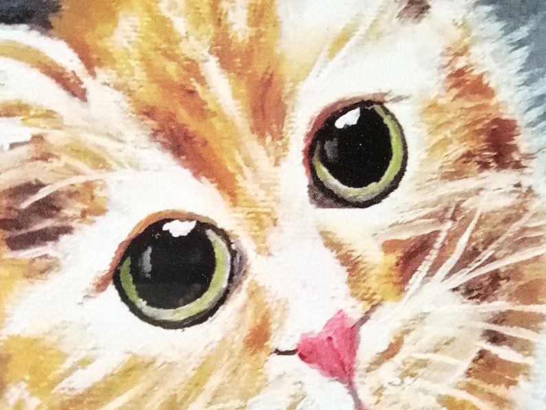 May include: Close-up of a cat's face with orange and white fur. The cat has green eyes and a pink nose.