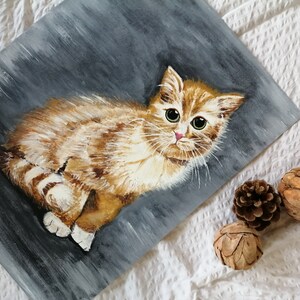 May include: A painting of a ginger kitten with green eyes, sitting on a gray background. The kitten is looking directly at the viewer.