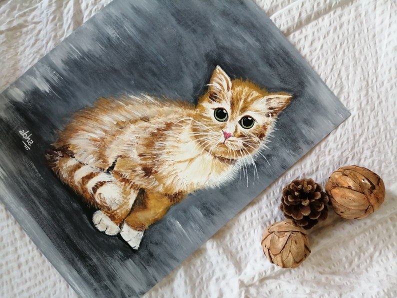 May include: A painting of a ginger kitten with green eyes, sitting on a gray background. The kitten is looking directly at the viewer.
