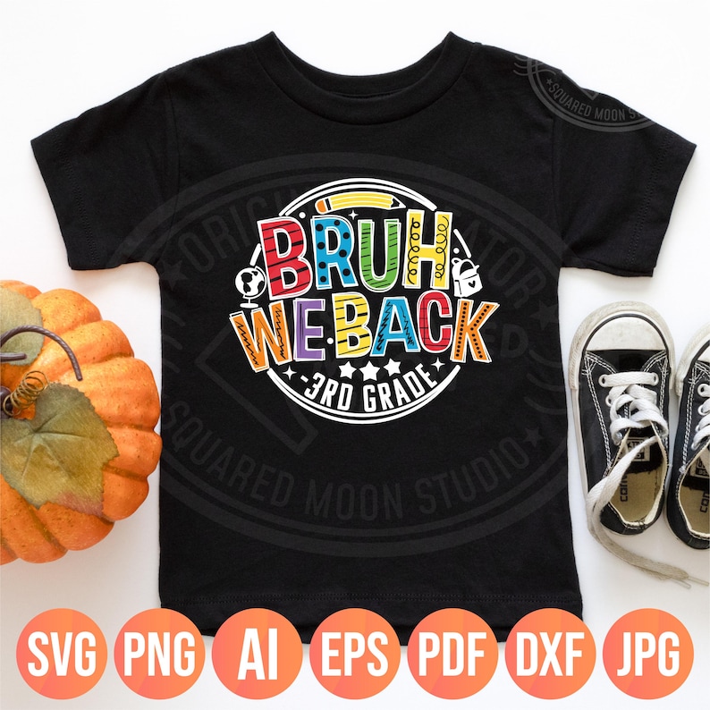 May include: Black short-sleeved t-shirt with a colorful graphic that says "BRUH WE BACK 3RD GRADE". The design includes a pencil, globe, and school supplies. A pumpkin and black sneakers are also visible.