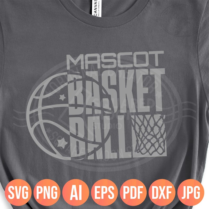 May include: Gray t-shirt with a basketball-themed design. The design features the words "MASCOT BASKET BALL" in a bold, blocky font, overlaid on a basketball graphic. Below the design are file type icons: SVG, PNG, AI, EPS, PDF, DXF, JPG.