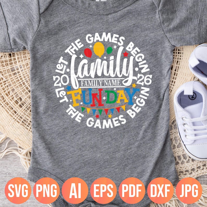 May include: A gray baby onesie with a circular design that reads "Let the Games Begin" around the edge. The word "Family" is in the center, with "Fun Day" below it. Colorful balloons and a banner are included in the design. The bottom of the onesie has file type icons.