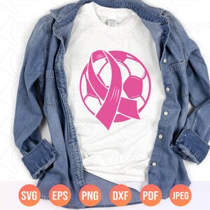 May include: A white t-shirt with a pink ribbon and soccer ball design. The ribbon is tied around the soccer ball.