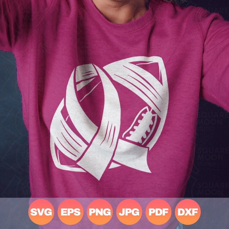 May include: A pink sweatshirt with a white outline of an American football with a ribbon wrapped around it.