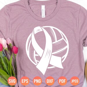 May include: A white silhouette of a volleyball with a white ribbon wrapped around it. The ribbon is tied in a bow at the top of the volleyball. The image is on a pink t-shirt.