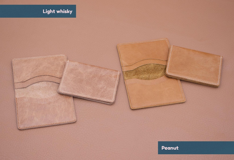 May include: Four leather wallets in two different colors. Two wallets are light brown and two are a lighter shade of brown. The wallets are all closed and have a stitched edge. The text "Light whisky" is at the top of the image and the text "Peanut" is at the bottom of the image.