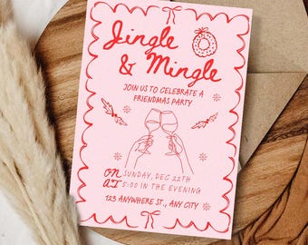 May include: Pink invitation with red text that reads "Jingle & Mingle" and "Join us to celebrate a Friendmas party." Includes illustrations of wine glasses, snowflakes, and a wreath. The invitation is on a wooden surface with a brown envelope.