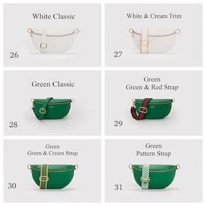 K&ouml;nnte beinhalten: Eine Kollektion von sechs halbmondf&ouml;rmigen G&uuml;rteltaschen in Wei&szlig; und Gr&uuml;n, jeweils mit goldenem Rei&szlig;verschluss, goldfarbenen Beschl&auml;gen und verstellbarem Riemen. Die Taschen sind von 26 bis 31 nummeriert und umfassen einfarbige Modelle, Varianten mit cremefarbenem Besatz, rot-gr&uuml;nen Streifen sowie gemusterten Riemen.