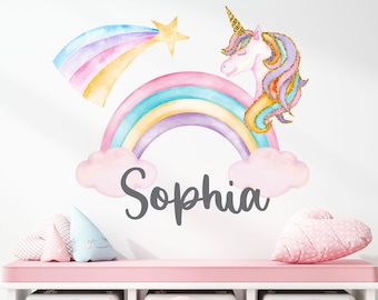 May include: A pink and white bench with a white shelf and three wicker baskets. The wall behind the bench has a rainbow with a unicorn and a shooting star. The name "Sophia" is written in gray below the rainbow.
