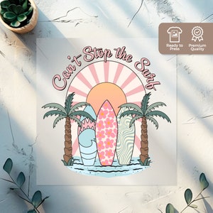 May include: A pink and blue graphic design with the text "Can't Stop the Surf" in a circle with a sun and palm trees. Three surfboards are in the center of the design.