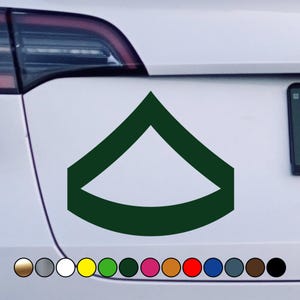 May include: A dark green military rank insignia sticker in the shape of a chevron. The sticker is designed to represent the rank of Specialist (SPC) in the United States Army.