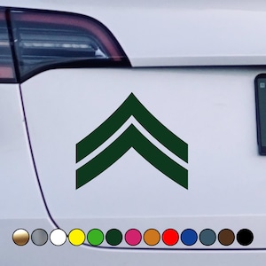 May include: Green and white military rank insignia sticker. The sticker features two chevrons, indicating the rank of Corporal.