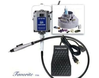 May include: A silver and gray Foredom SR rotary tool kit with a black foot pedal and a detailed diagram of the tool's components. The kit includes a flexible shaft and a variety of accessories. The text "Favorite USA" is at the bottom.