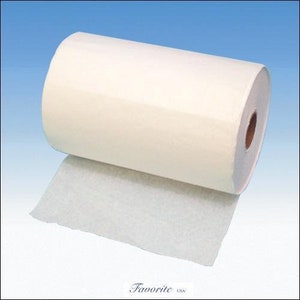May include: A roll of white, non-woven interfacing fabric. The fabric is rolled up and partially unrolled, showing the texture of the material.