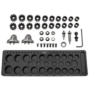 May include: A black metal tool tray with 22 different sized holes for holding various tools. The tray is labeled "GRS" and includes a set of metal rings, a set of metal pins, and two metal bell-shaped tools.