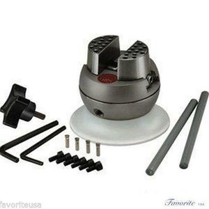 May include: A silver metal jewelry making vise with a white base and two silver metal rods. The vise has a red knob and a black knob. The vise is on a white base with a black knob.