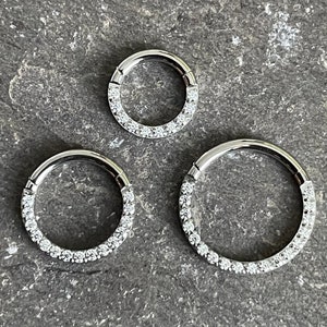 Stunning Circular hinged segment ring with front face paved clear gems. Made from Titanium. Suitable for various piercings