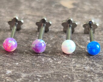 May include: Four silver body jewelry pieces with opal-like stones. The stones are pink, purple, white, and blue.