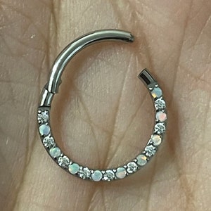 Stunning Circular hinged segment ring with front face paved rainbow opal and clear gems. Made from Titanium. Suitable for various piercings