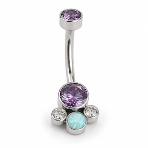 May include: A curved barbell belly button ring featuring a silver-toned metal shaft. The top end has a single round purple gemstone. The bottom end features a large central purple gemstone flanked by two clear stones and one light blue opal stone.