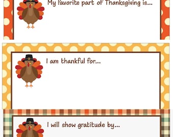 May include: Three printable Thanksgiving cards featuring a cartoon turkey wearing a pilgrim hat. The cards have different backgrounds: orange with white polka dots, yellow with white polka dots, and brown and green plaid. The text on the cards reads: "My favourite part of Thanksgiving is...", "I am thankful for...", and "I will show gratitude by...".