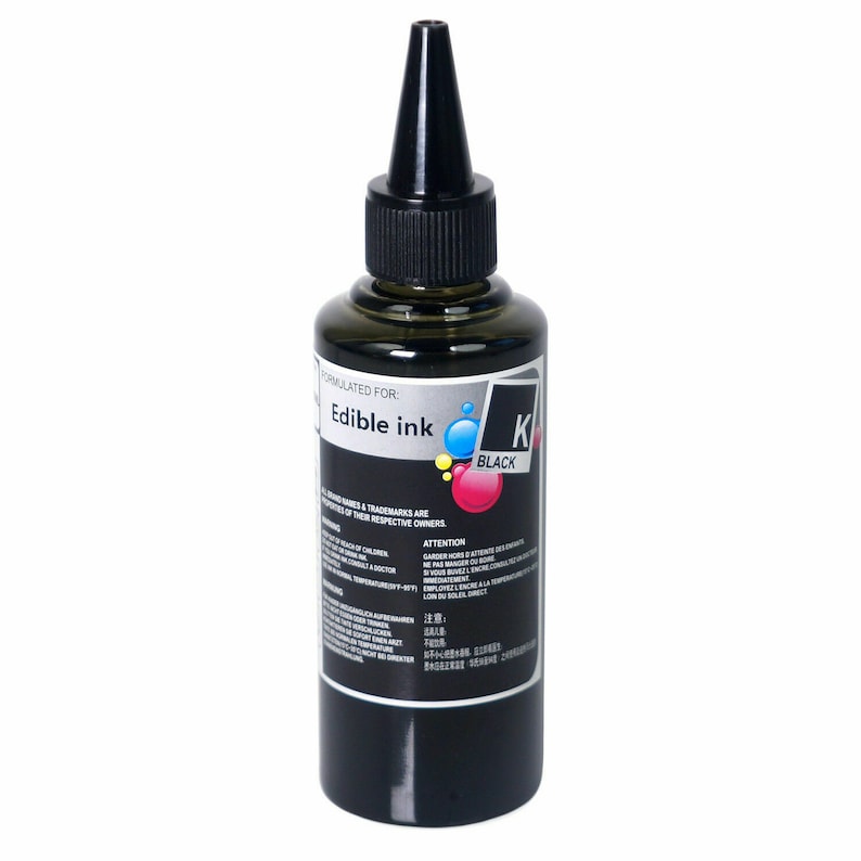 May include: A black bottle of edible ink labeled "Edible Ink" and "K Black". The bottle has a black cap with a pointed tip.