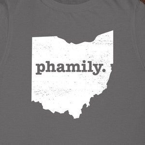 May include: A gray t-shirt with a white outline of the state of Ohio and the word "pha mily." printed on it.
