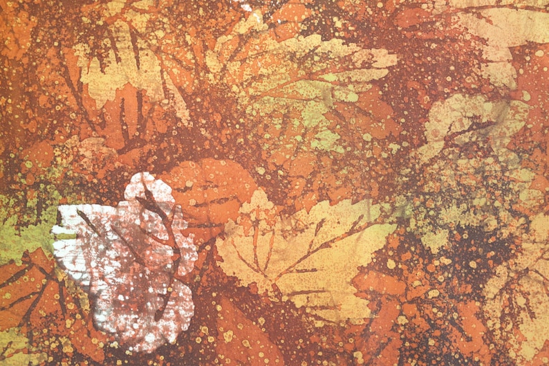 May include: Abstract art print with a brown, orange, and yellow color scheme. The print features a pattern of leaves and splatters of paint.
