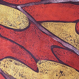 May include: Abstract pattern fabric with a red, yellow, and brown color scheme. The fabric has a textured surface and a geometric design.