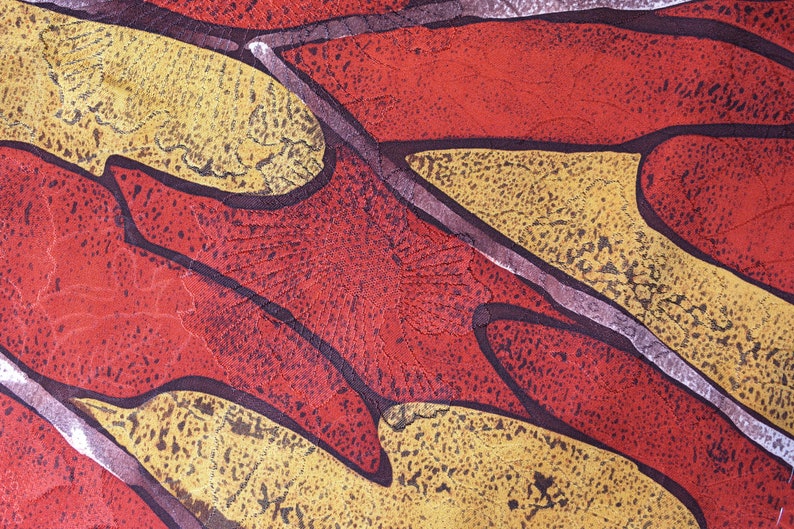 May include: Abstract pattern fabric with a red, yellow, and brown color scheme. The fabric has a textured surface and a geometric design.