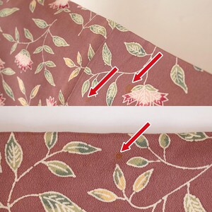 May include: A close-up of a pink fabric with a floral pattern. There are several brown stains on the fabric.