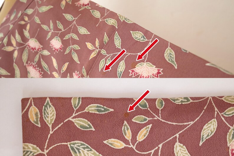 May include: A close-up of a pink fabric with a floral pattern. There are several brown stains on the fabric.