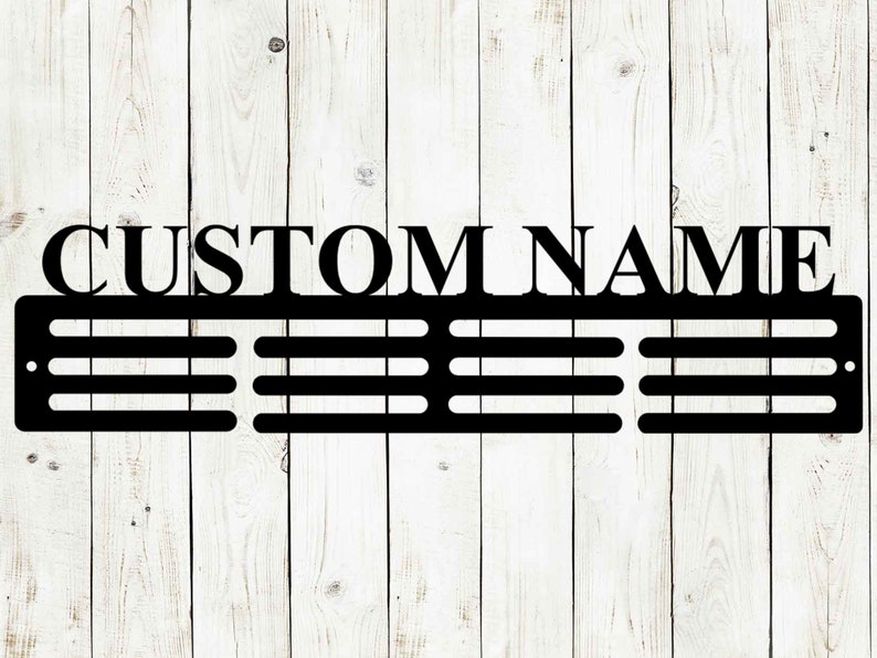 May include: Black metal sign with the words "CUSTOM NAME" at the top. Below the text are three horizontal rows of evenly spaced slots. The sign is mounted on a white wooden plank background.