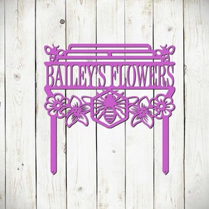 May include: Purple metal garden sign with the text "Bailey's Flowers" and a bee and honeycomb design.