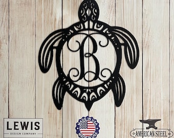 May include: Black metal turtle silhouette with a decorative scroll letter B in the centre. The turtle is on a woodgrain background with the text "Lewis - Design Company", "Made in USA", and "American Steel" visible.
