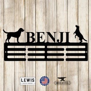 May include: Black metal medal rack with the name "BENJI" and two dog silhouettes. The rack has 10 slots for medals. The rack is made in the USA by American Steel.