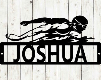 May include: Black metal silhouette of a swimmer with the name "Joshua" written below.