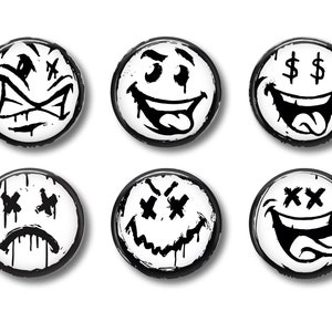 May include: Six black and white smiley face buttons with different expressions. The buttons have a black border and a white background. The expressions include a happy face with a tongue sticking out, a sad face with tears, a surprised face with eyes crossed out, a face with dollar signs for eyes, a face with X's for eyes, and a face with a crazy grin.