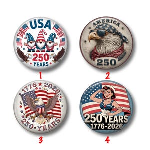 May include: Four round patriotic buttons with red, white, and blue designs. One features gnomes, another an eagle wearing sunglasses, a third an eagle with a flag, and the last a woman saluting. All buttons have "250 YEARS" and "1776-2026" text.
