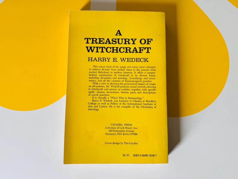 May include: A yellow book titled "A Treasury of Witchcraft" by Harry E. Wedeck. The book's cover features black text and a description of witchcraft's history and practices. The book is from Citadel Press.