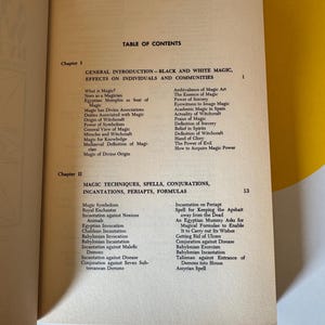 May include: An open book displays a table of contents with the title "GENERAL INTRODUCTION - BLACK AND WHITE MAGIC, EFFECTS ON INDIVIDUALS AND COMMUNITIES." The page is aged with a yellow background.