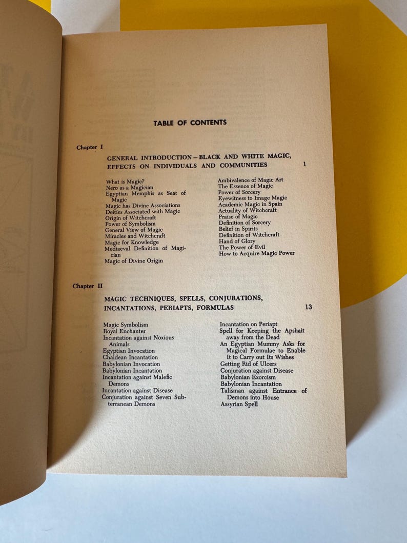 May include: An open book displays a table of contents with the title "GENERAL INTRODUCTION - BLACK AND WHITE MAGIC, EFFECTS ON INDIVIDUALS AND COMMUNITIES." The page is aged with a yellow background.