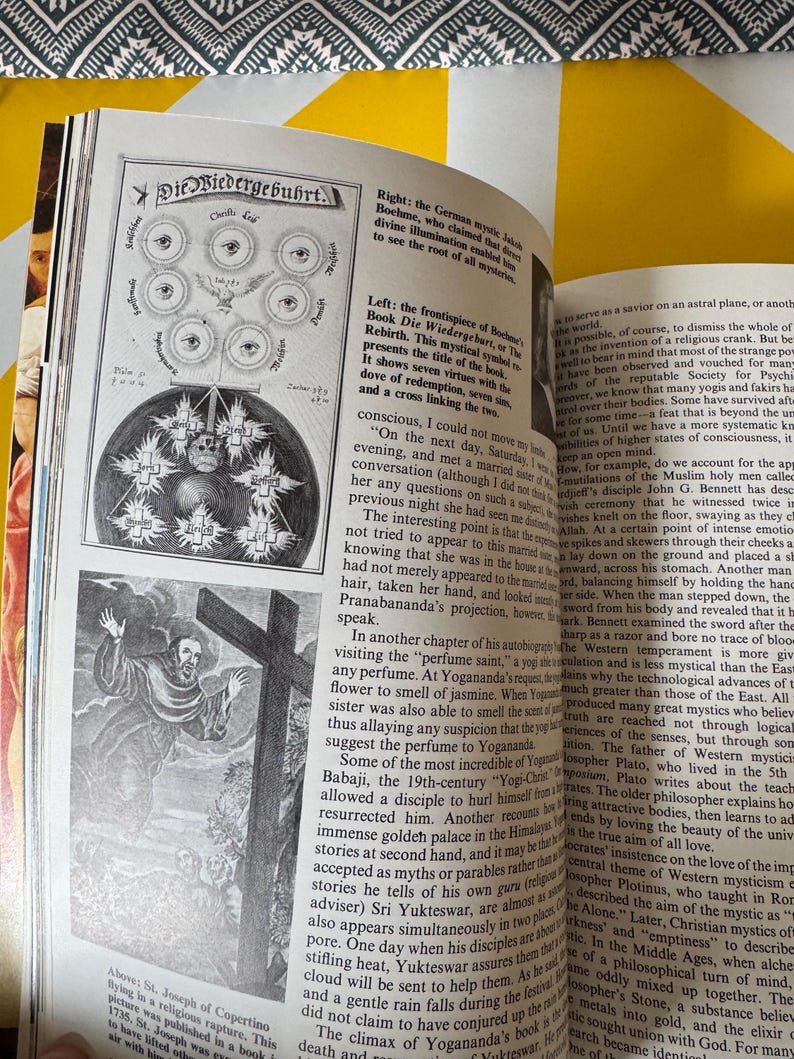 May include: An open book with illustrations and text. One page features a diagram with eyes and text in German. Another shows a drawing of a religious figure with a cross. The book appears to be about mysticism.