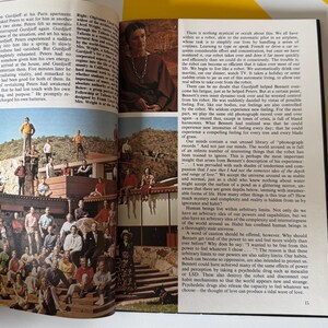 May include: An open book with images and text. One image shows a woman in a brown dress. Another shows a group of people on a rooftop. The text discusses the human experience and the limits of perception.